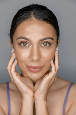 Beautiful healthy smiling caucasian woman is doing beauty procedures at spa and healthcare salonの写真素材