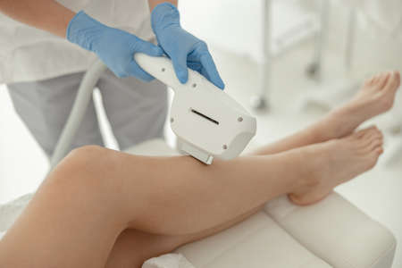 Beautiful healthy smiling caucasian woman is doing beauty procedures at spa and healthcare salonの写真素材
