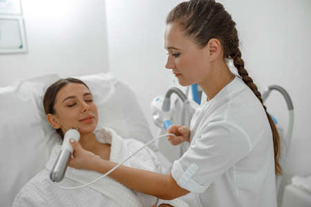 Beautiful healthy smiling caucasian woman is doing beauty procedures at spa and healthcare salon
