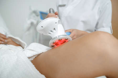 Beautiful healthy smiling caucasian woman is doing beauty procedures at spa and healthcare salonの写真素材