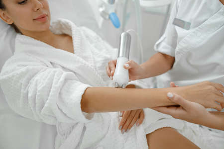 Beautiful healthy smiling caucasian woman is doing beauty procedures at spa and healthcare salonの写真素材