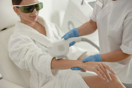 Beautiful healthy smiling caucasian woman is doing beauty procedures at spa and healthcare salonの写真素材