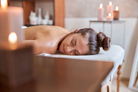 Young atractive female in massage salon is having beauty and healthcare proceduresの写真素材