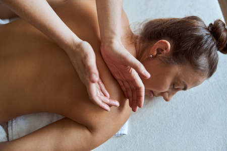 Young atractive female in massage salon is having beauty and healthcare proceduresの写真素材
