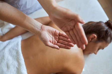 Young atractive female in massage salon is having beauty and healthcare proceduresの写真素材
