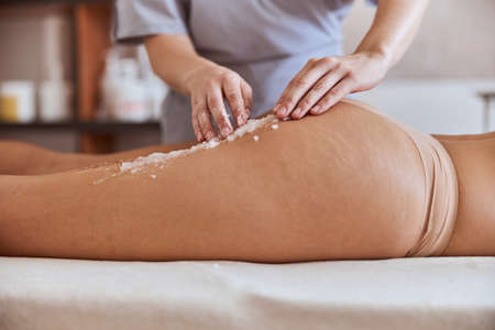 Young atractive female in massage salon is having beauty and healthcare proceduresの写真素材