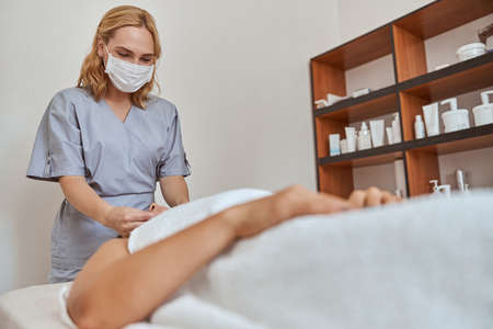 Young atractive female in massage salon is having beauty and healthcare proceduresの写真素材