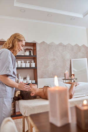 Young atractive female in massage salon is having beauty and healthcare proceduresの写真素材