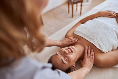 Young atractive female in massage salon is having beauty and healthcare proceduresの写真素材