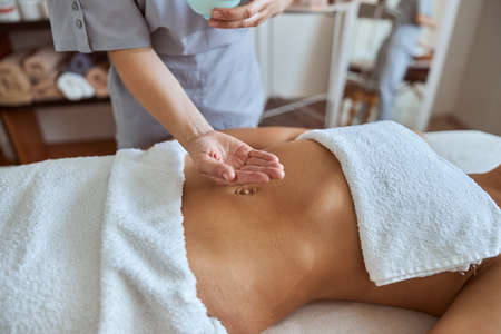 Young atractive female in massage salon is having beauty and healthcare procedures