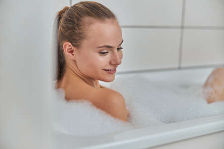 Young female with natural healthy fresh skin at home bathroom