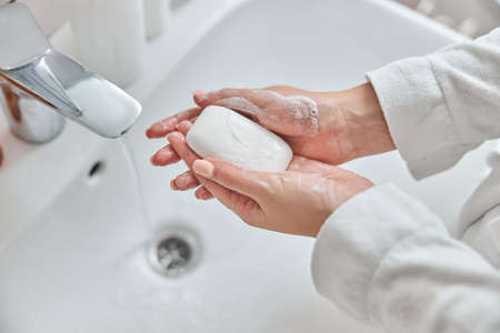 Young female with natural healthy fresh skin at home bathroomの写真素材