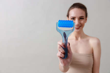 Studio beauty portrait of a young, healthy, beautiful, fresh skinned caucasian woman on a gray...