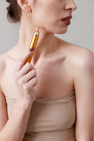 Studio beauty portrait of a young, healthy, beautiful, fresh skinned caucasian woman on a gray backgroundの写真素材