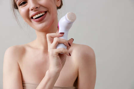 Studio beauty portrait of a young, healthy, beautiful, fresh skinned caucasian woman on a gray backgroundの写真素材