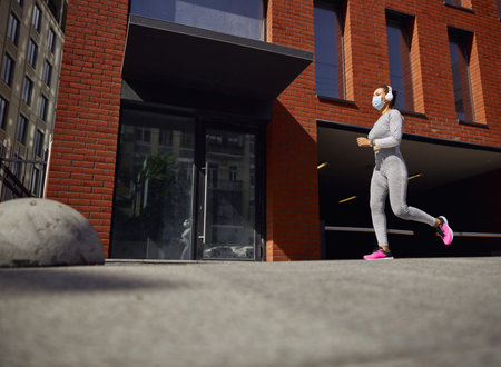 Beautiful healthy cheerful smily woman workout in an urban city streetの写真素材