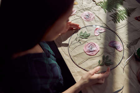 Confident female florist is working with dryed flowers in cozy flower shopの写真素材