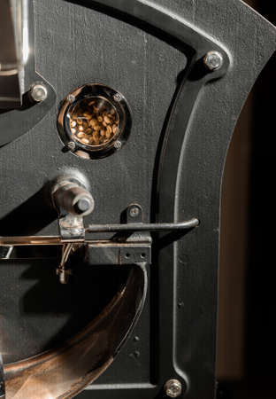 Coffee processing. Roastery, roasting machine and fresh beansの写真素材