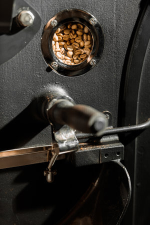 Coffee processing. Roastery, roasting machine and fresh beansの写真素材