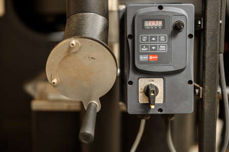 Coffee processing. Roastery, roasting machine and fresh beansの写真素材