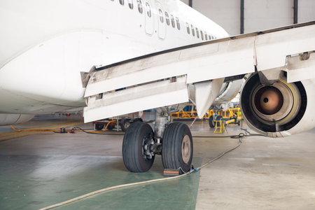 Close up shot of aircraft wheel, landing gear in airport hangar