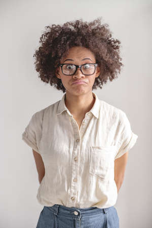 Pretty young lady in casual clothes looking at camera