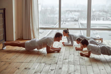 All family doing plank together at homeの写真素材