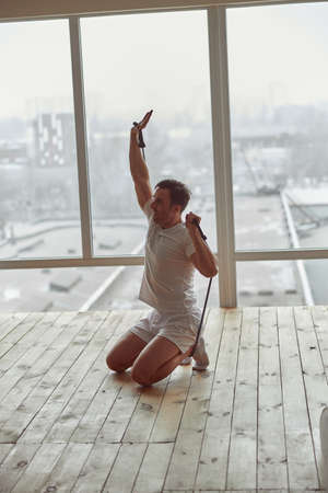 Determned guy doing training indoors during quarantine