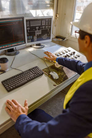 Male engineer using desktop computer at factoryの写真素材