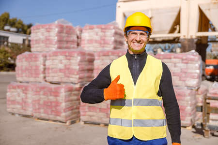Cheerful man factory worker showing approval gestureの写真素材