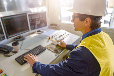 Male worker using computers at manufacturing plantの写真素材