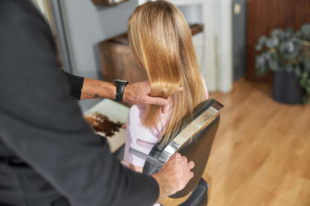 Happy beautiful light hair caucasian woman at beauty salonの写真素材