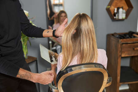 Happy beautiful light hair caucasian woman at beauty salonの写真素材