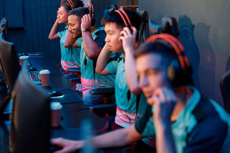 Team of professional gamers playing on pc in gaming clubの写真素材