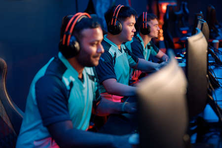Young Asianman gaming with his friends in cyber clubの写真素材