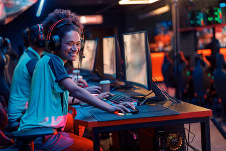 Esports team playing game on computers in gaming club