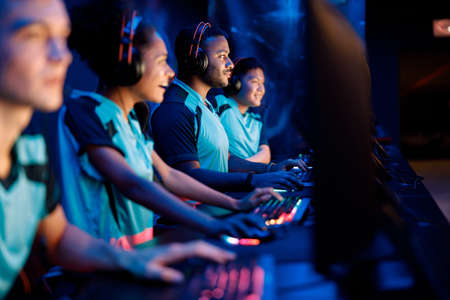 Team of professional gamers playing on pc in gaming clubの写真素材