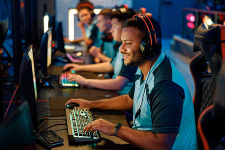 Team of professional gamers playing on pc in gaming clubの写真素材