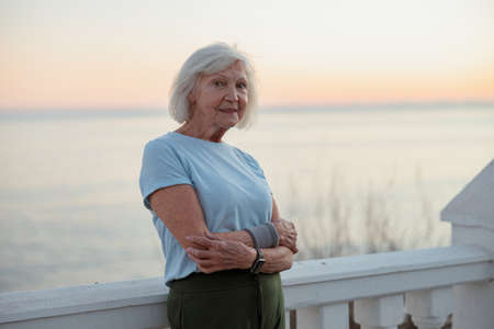 Attractive female pensioner breathing fresh air outdoorsの写真素材