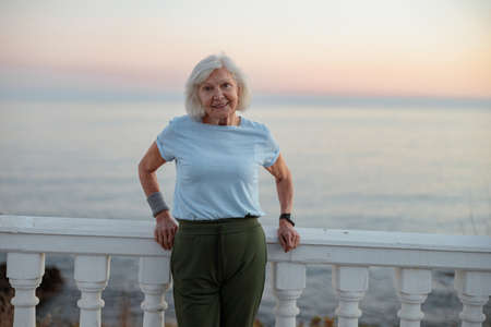 Good looking senior lady posing at beautiful parkの写真素材