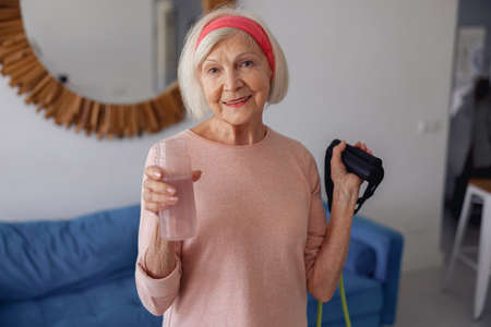 Portrait of senior woman exercising at home