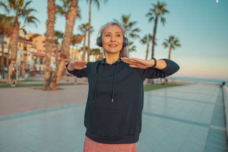 Sporty woman warming up before exercising on the seafrontの写真素材