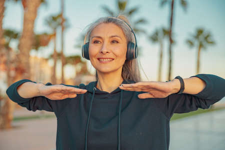Sportswoman warming up before exercising on the seafrontの写真素材