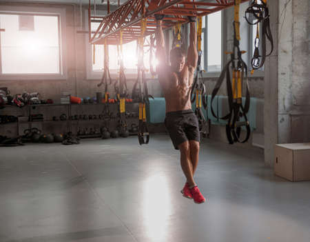 Athletic strong man training in the gym