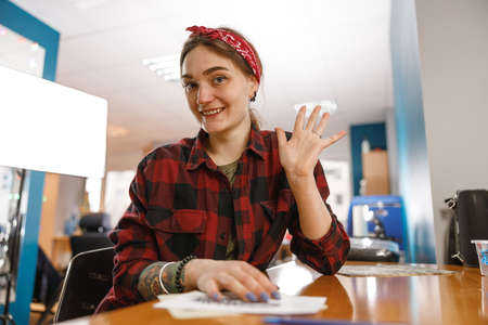 Portrait of beautiful woman tattoo master sitting in her office