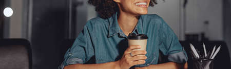 Happy Afro American woman in glasses working at workplace