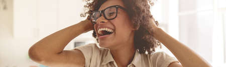 Smiling young lady wearing glasses and enjoying sunny day