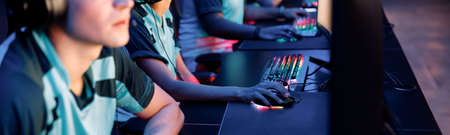 Young gamers playing online video game in computer clubの写真素材