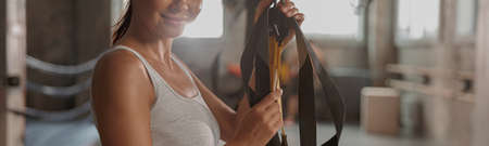 Pretty young woman training in fitness club