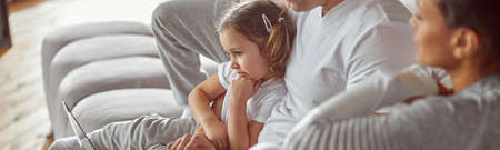 All family using laptop together at homeの写真素材